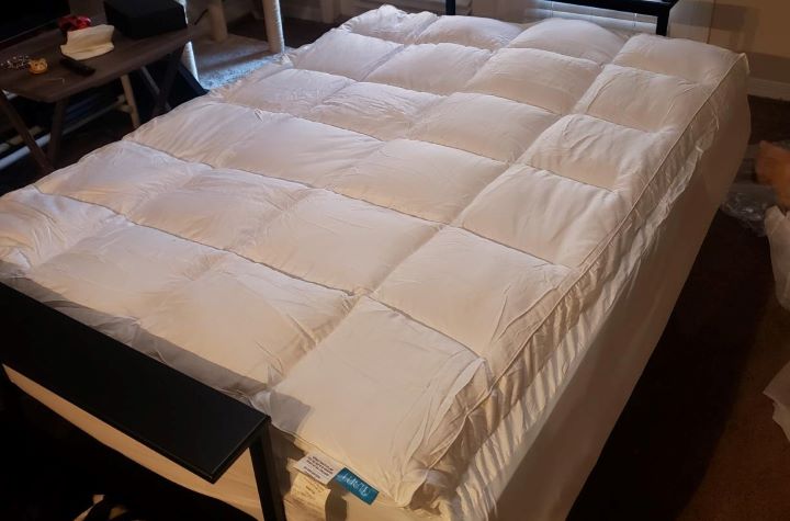 Checking the comfortability of the hypoallergenic mattress topper