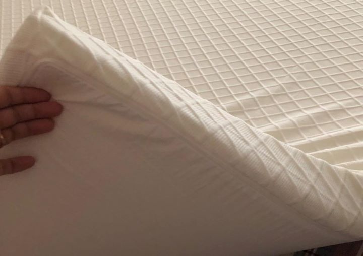 Examining the weight and softness of the mattress topper